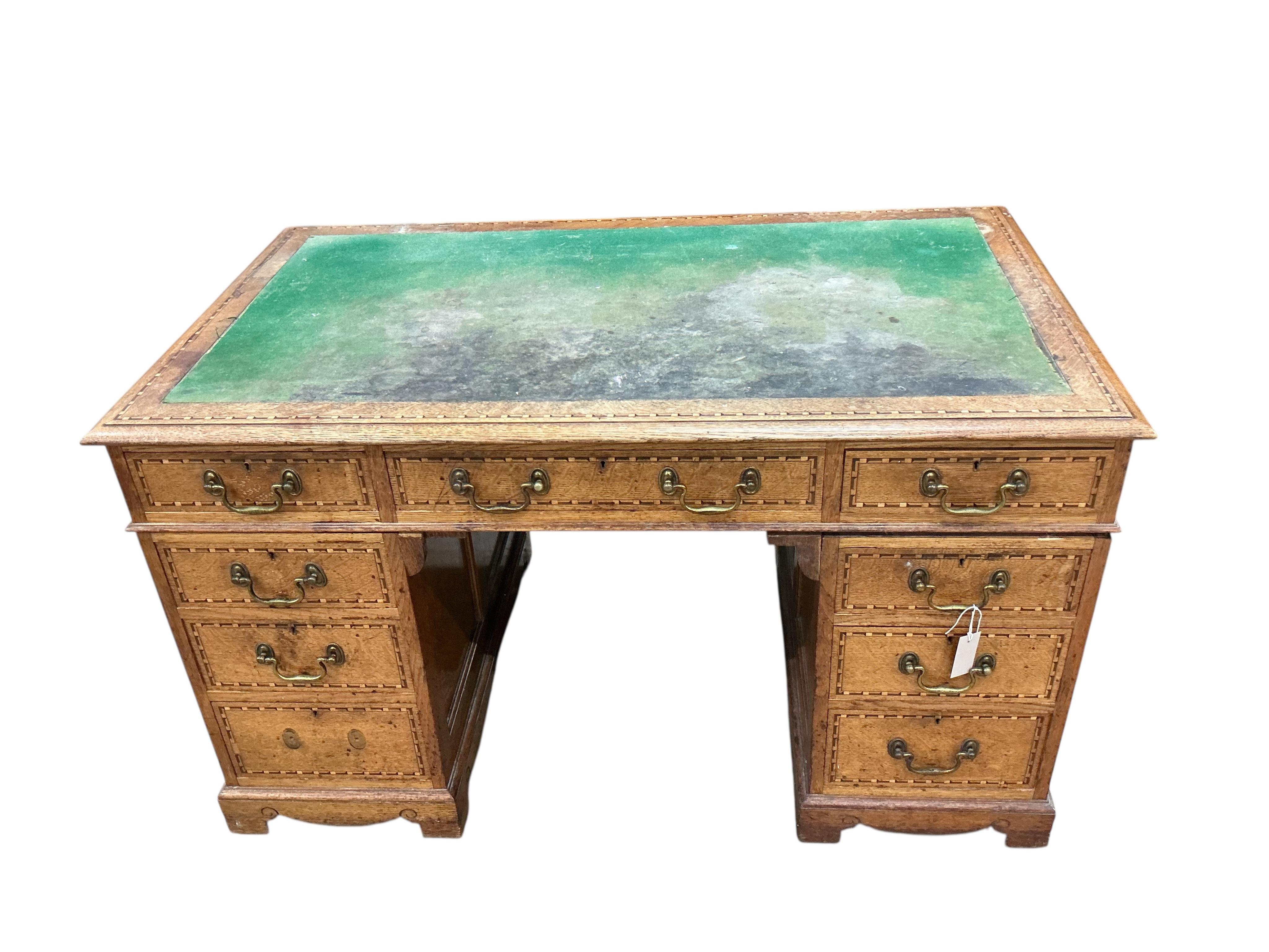 A late Victorian parquetry inlaid oak pedestal desk bears ivorine label Robson & Sons, Newcastle-on-Tyne, width 129cm, depth 76cm, height 76cm